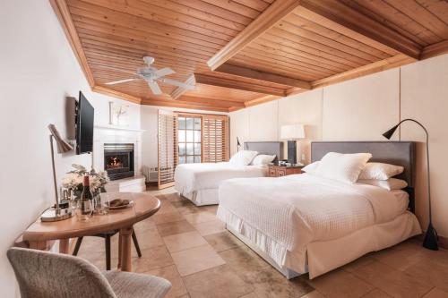 a large bedroom with two beds and a fireplace at Inn On SummerHill in Summerland