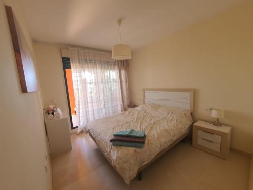 niewielka sypialnia z łóżkiem i oknem w obiekcie Luxyry apartament Benidorm w mieście Finestrat