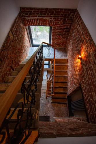 a staircase in a brick building with a window at Ogrodowa Premium in Gorlice