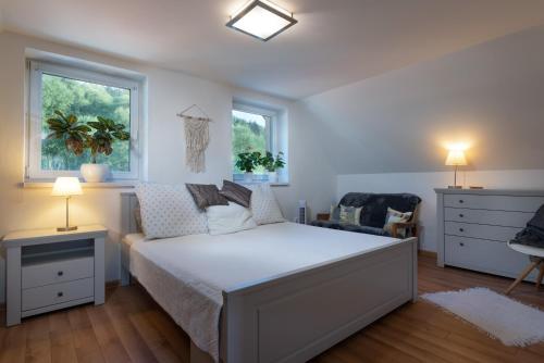 A bed or beds in a room at Rekreačný domček Flower Garden - Self Check In