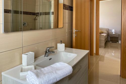 bagno con lavandino e specchio di Hyele Accommodation Experience a Casal Velino