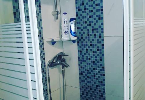 a bathroom with a shower with a glass wall at ΘΕΑ ΠΑΝΟΡΑΜΑ in Paliámpela