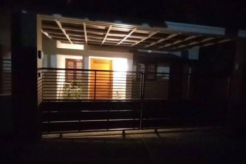 a house with a balcony with a window at night at Eka Homes 3BHDK Villa in Trivandrum