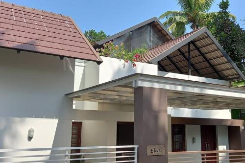 a white house with a red roof at Eka Homes 3BHDK Villa in Trivandrum