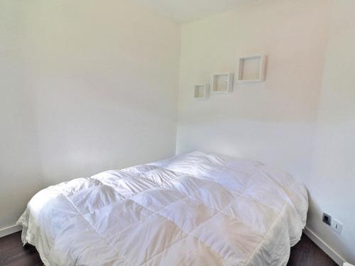 a white bedroom with a white bed in it at Appartement La Tania, 2 pièces, 4 personnes - FR-1-182A-5 in Courchevel