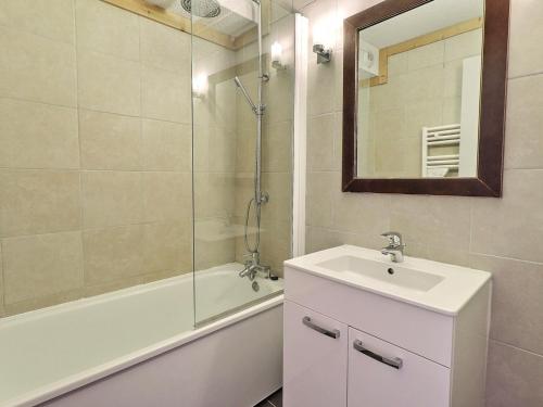 a bathroom with a sink and a shower with a mirror at Appartement La Tania, 2 pièces, 4 personnes - FR-1-182A-5 in Courchevel