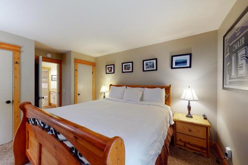 a bedroom with a large bed and a table with a lamp at The Summit 206 in Old Mammoth