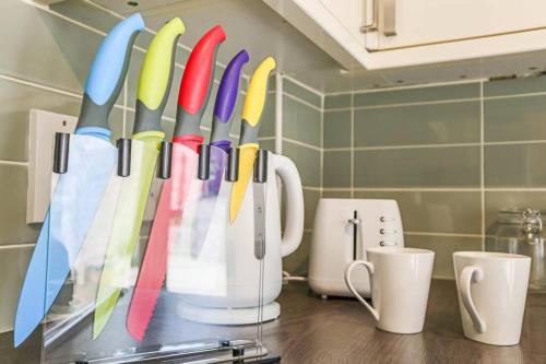 a bunch of utensils are hanging on a kitchen counter at Delightful 2 Bed Room Property, Free Off Road Parking. in Cleethorpes