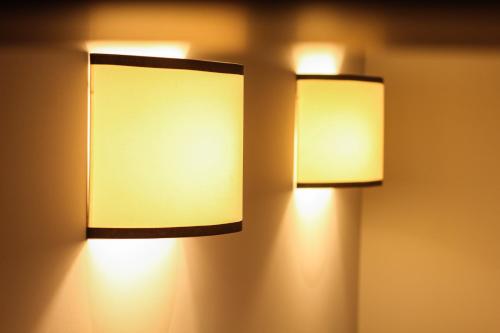 two lights are hanging on a wall at SIBL LOFTS in Thessaloniki