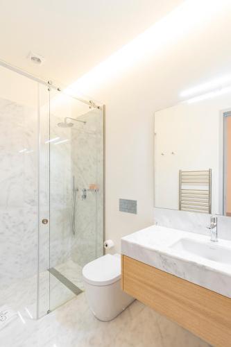 a bathroom with a shower and a sink and a toilet at Mouzinho Village River in Porto
