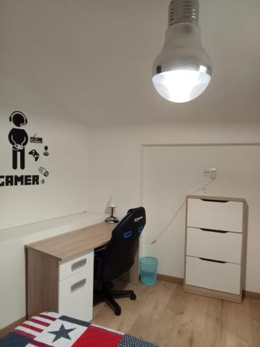 an office with a desk and a black chair at ALOJAMIENTO RURAL EL CARRIL in Pegalajar