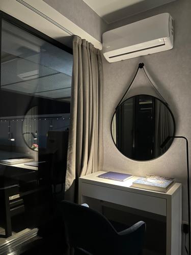 a room with a mirror and a desk with a chair at The SPOT apartments - Orbi Beach Tower in Batumi