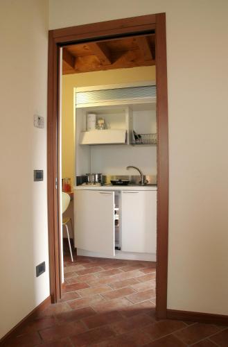an open door to a kitchen with a sink at Bed&Wine in Negrar