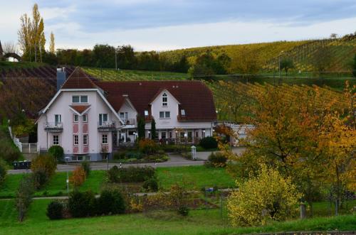 a large white house with a red roof at Castell Hotel & Restaurant in Leinsweiler