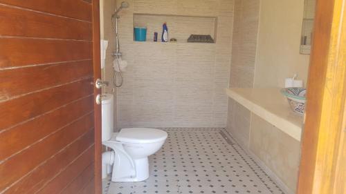 a small bathroom with a toilet and a sink at Gîte avec piscine privé in Agadir