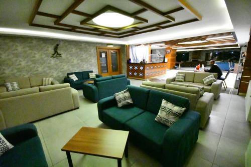 a large living room with couches and a table at Snowflake Dag Hotel & SPA in Sarıkamıs