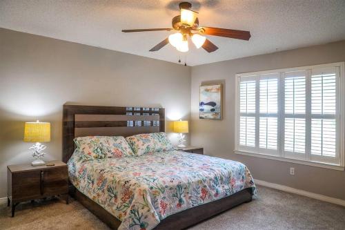 a bedroom with a bed and a ceiling fan at Pool House, Short Drive to Beach, Grill, Smart TV in Navarre