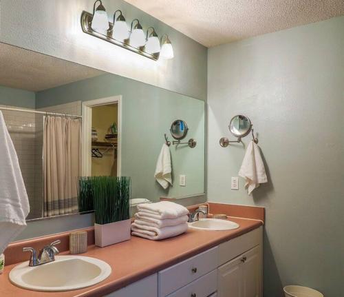 a bathroom with two sinks and a large mirror at Pool House, Short Drive to Beach, Grill, Smart TV in Navarre