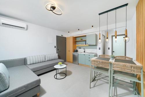 a living room with a couch and a table at Olia Thassos - Luxury Apartments in Limenas