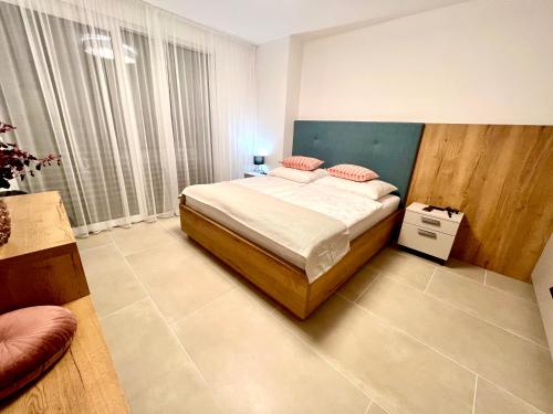 een slaapkamer met een bed en een groot raam bij ZADAR Panorama Sea View Apartments in Zadar