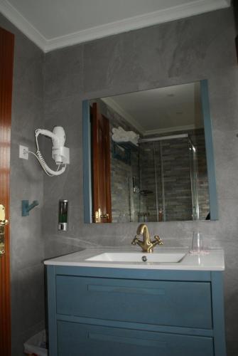 a bathroom with a sink and a mirror at El ParaÍso de Guriezo in Pomar