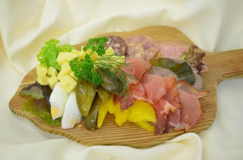 a plate of food with meat and vegetables on a table at Castell Hotel & Restaurant in Leinsweiler
