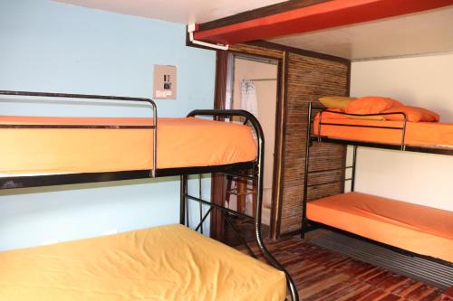 a dorm room with three bunk beds in it at The Spot in Esterillos