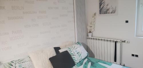 a bedroom with a wall with writing on it at Sleep and drive Suites in Sarajevo