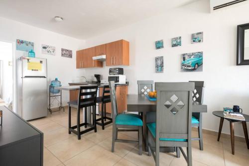 a kitchen with a table and chairs and a refrigerator at New Ampartment For Rent in Jarretadera