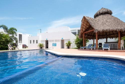 a swimming pool with a gazebo at a resort at New Ampartment For Rent in Jarretadera