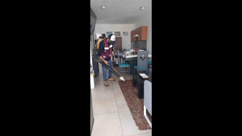 two men in a kitchen with a vacuum cleaner at New Ampartment For Rent in Jarretadera