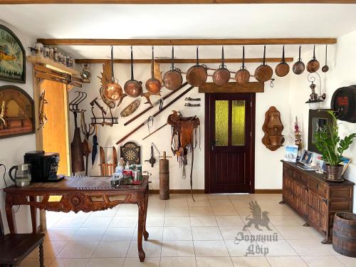 a kitchen with pots and pans hanging on the wall at Villa Zoryany Dvir in Skhidnitsa