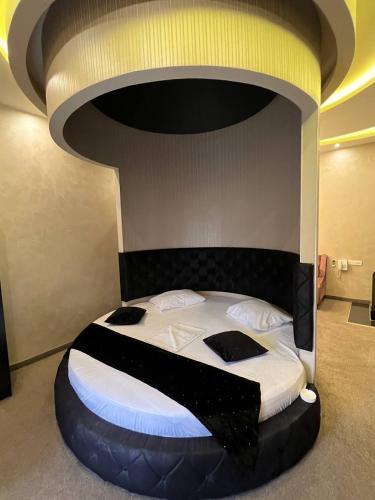 a bed in a room with a large bed with aigunigunigun at Hotel Roma & Tours in Yerevan