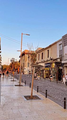 a street with two trees in the middle of a street at The Fifty Condo in Heraklio Town