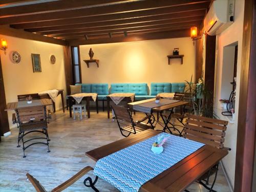 a restaurant with tables and chairs in a room at Hotel Mary's House in Selcuk