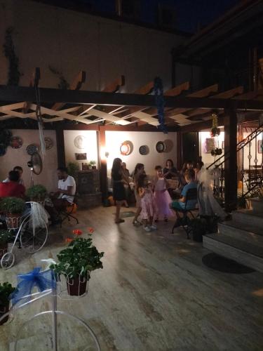 a group of people standing and sitting in a room at Hotel Mary's House in Selcuk