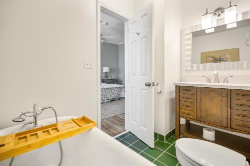 a bathroom with a sink and a toilet and a tub at Liberty Hall Bed and Breakfast in Pendleton