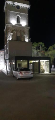 a car parked in front of a building at night at Boutique hotel in Poti