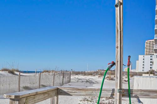 a green hose is attached to a wooden bench at Gulf House 202 in Gulf Shores
