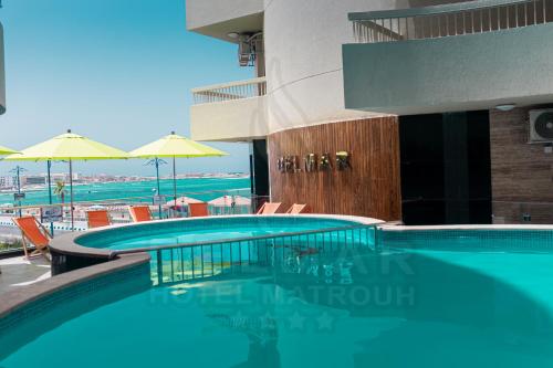 a swimming pool with a view of the beach at Delmar Hotel Matrouh in Marsa Matruh