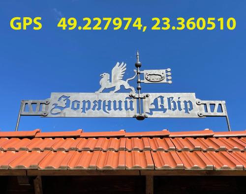 a sign on top of a building with a roof at Villa Zoryany Dvir in Skhidnitsa