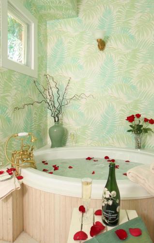 a bathroom with a bath tub with roses in it at Spencer Hotel & Spa Chautauqua in Chautauqua