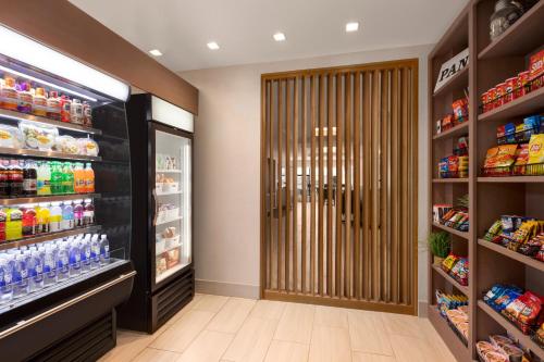 a grocery store aisle with a door in a store at Holiday Inn Express & Suites Denver Airport by IHG in Denver