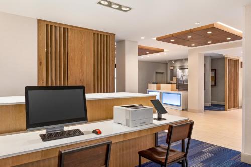 an office with a desk with a computer on it at Holiday Inn Express & Suites Denver Airport by IHG in Denver