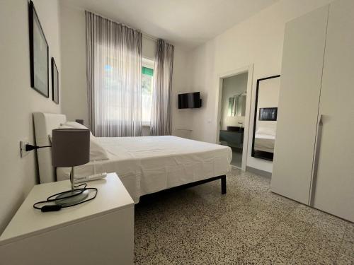 a bedroom with a bed and a desk with a lamp at Bed and coffee Rooms Portoferraio in Portoferraio