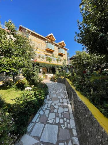 a stone path in front of a building at House 1960 in Lin