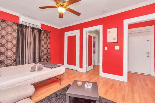 a living room with red walls and a couch at Calm Cozy Oasis in the Heart of Houston by Toyota Center in Houston