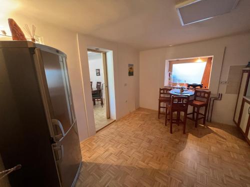 a kitchen and dining room with a table and chairs at Apartment Sawetz - Ptuj in Ptuj