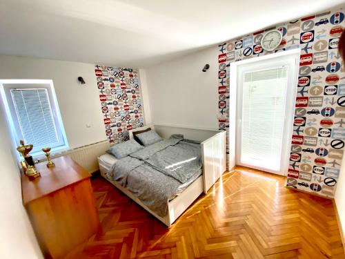 a bedroom with a bed and a wall of plates at Apartment Sawetz - Ptuj in Ptuj