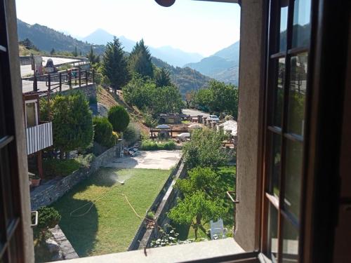 a view from a window of a mountain valley at MAISON BLANC in Aymavilles